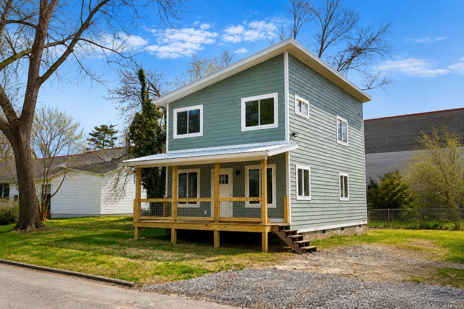 A Compact Cottages three-bedroom cottage with a covered porch