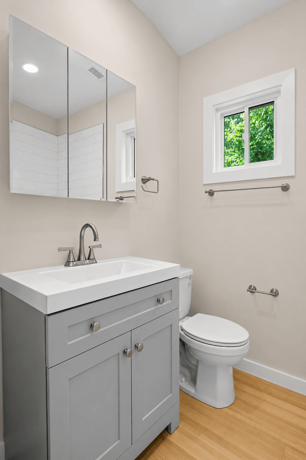 Master on Main 3 Bed, bathroom with grey shaker vanity, brushed nickel fixtures and bamboo floor
